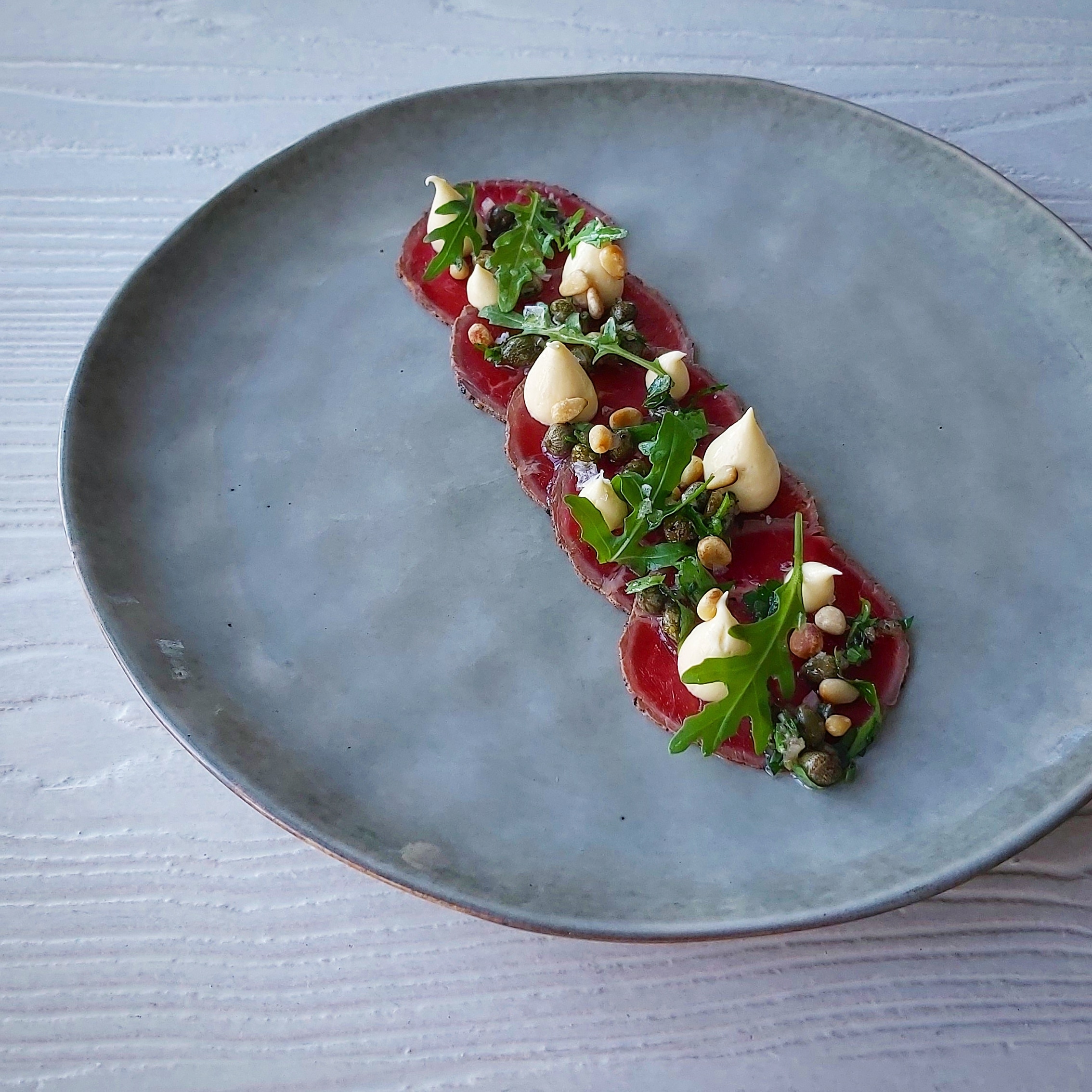 Beef carpaccio with capers and arugula